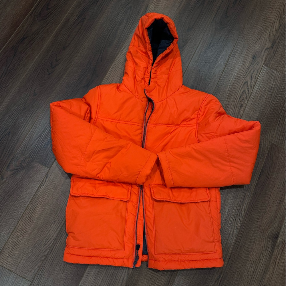 Orange puffer jacket. Perfect for skiing or being outdoors